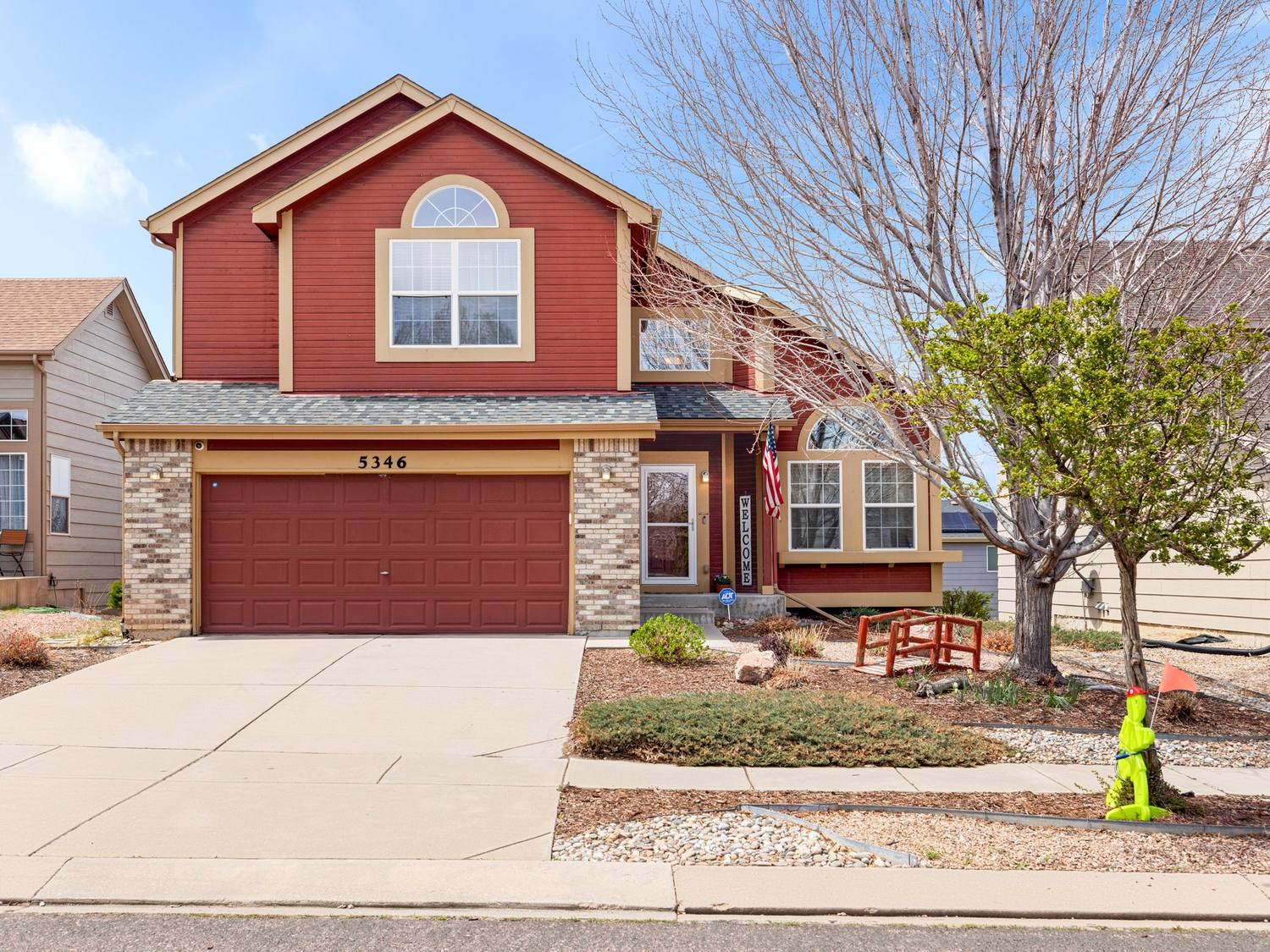 Two-story suburban home in Colorado Springs with red siding
